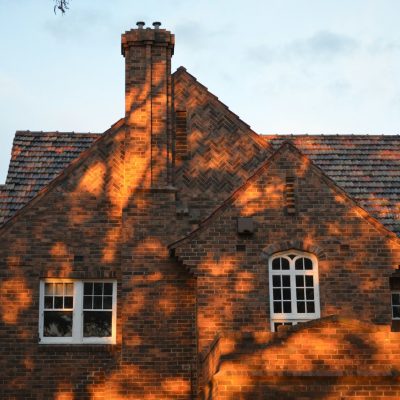 brown brick house under blue sky during daytime