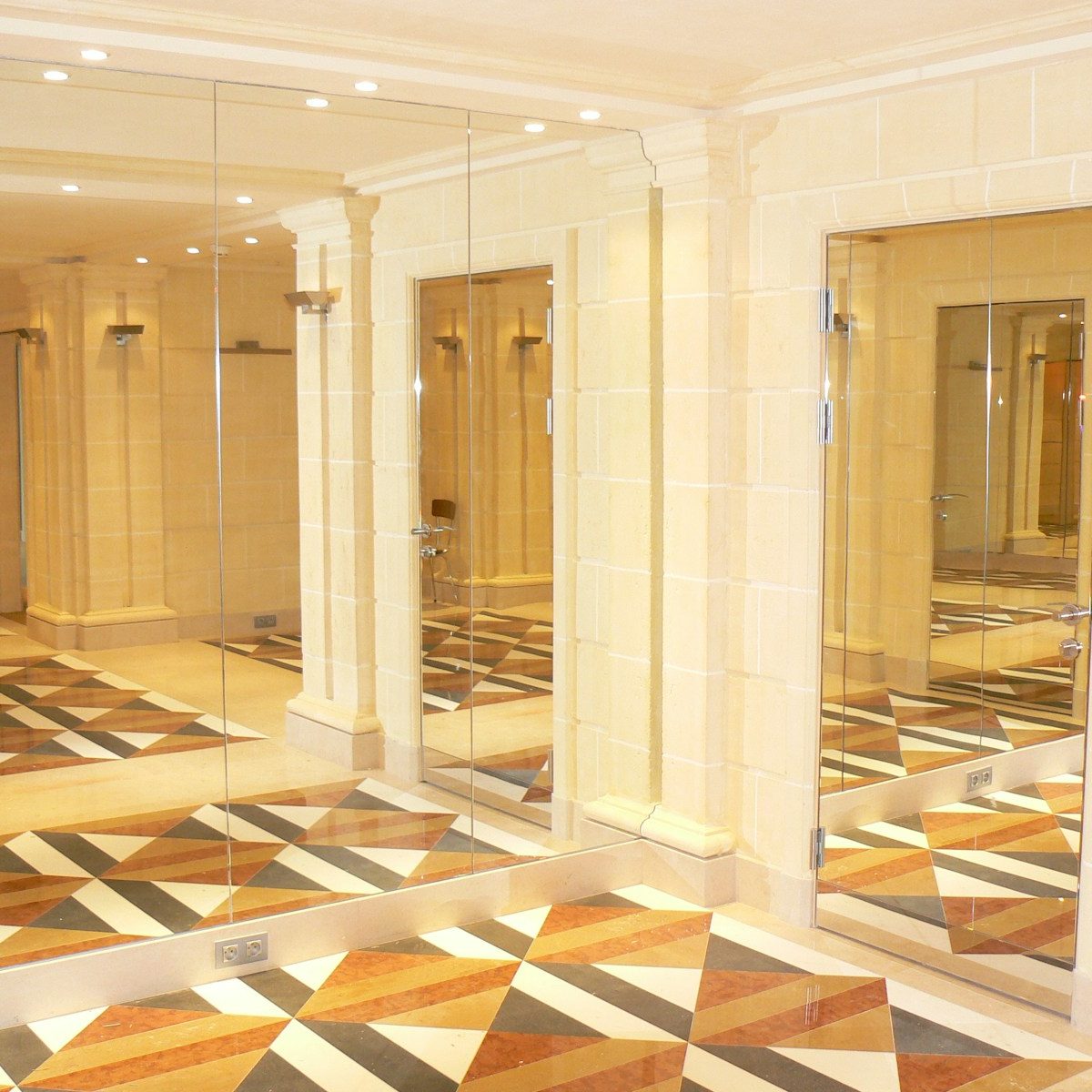 A large room with a checkered floor and mirrors